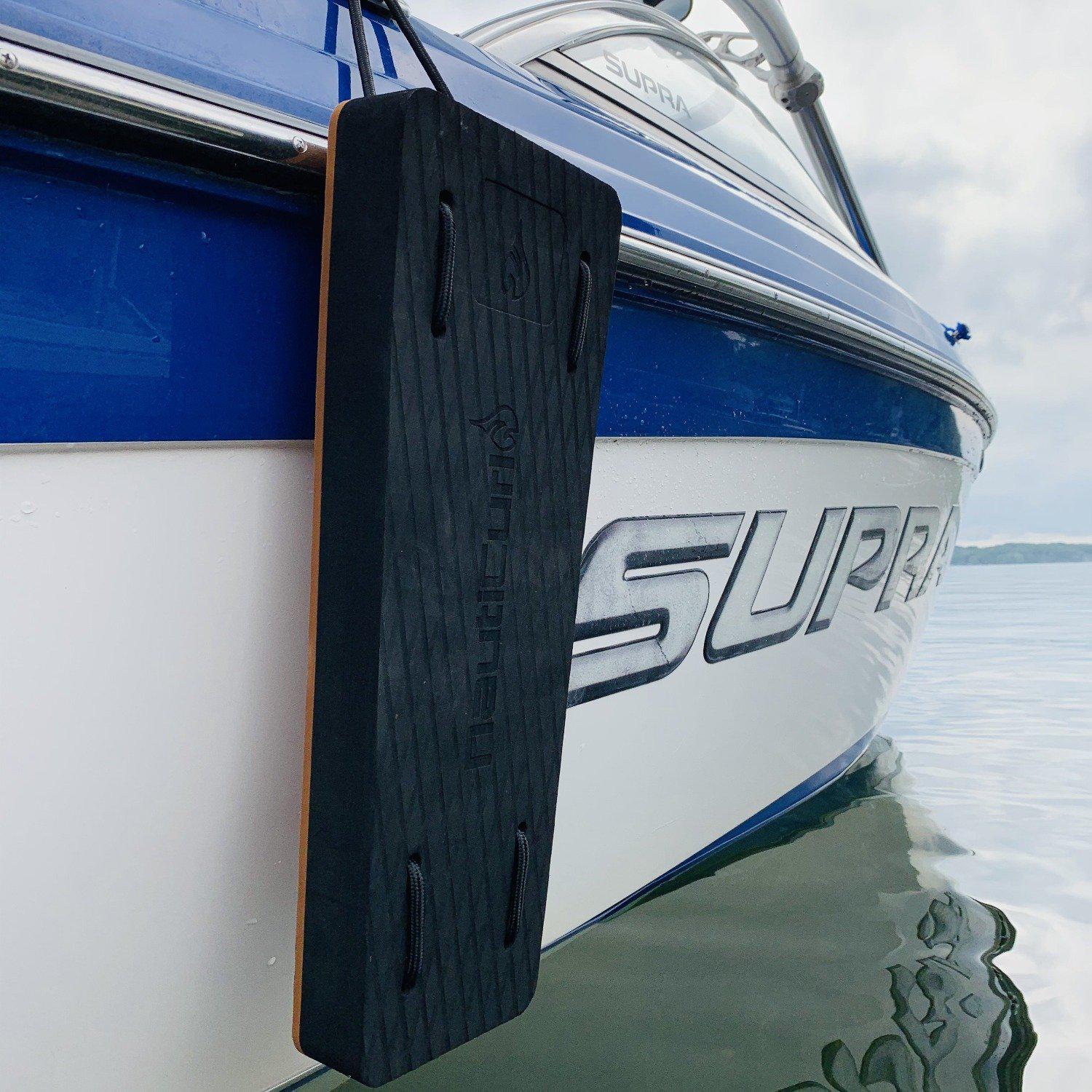 Black NautiFender flat boat fender by NautiCurl LLC, inflatable boat bumper for dock protection and boat safety.