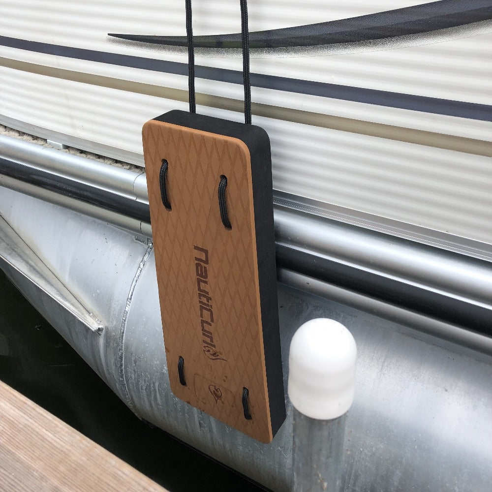 NautiFender flat boat fender from NautiCurl LLC, showing the durable inflatable boat bumper with a gray exterior and black attachment points.