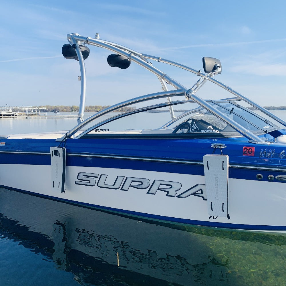 NautiFender flat boat fender by NautiCurl LLC hanging on a boat, made of durable material for protecting boat hulls during docking.