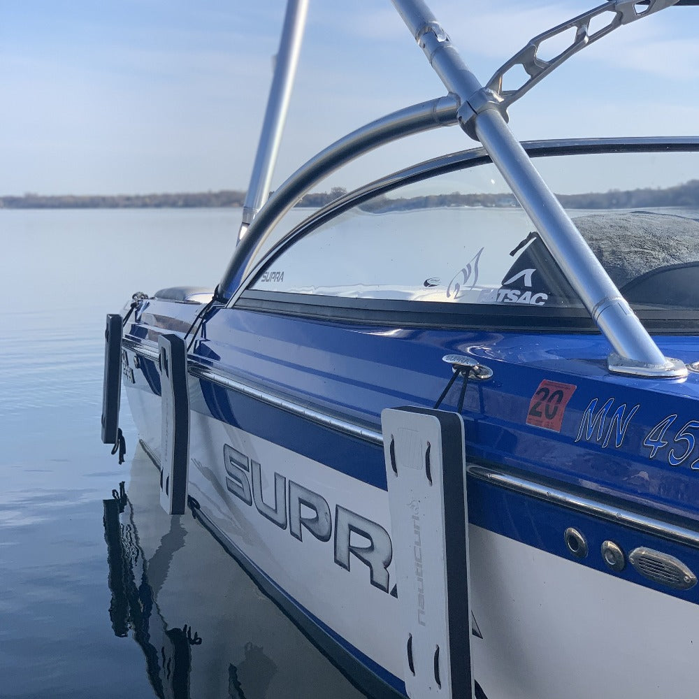 NautiFender flat boat fender from NautiCurl LLC, showing a durable, rectangular boat bumper with attachment points on a boat side.