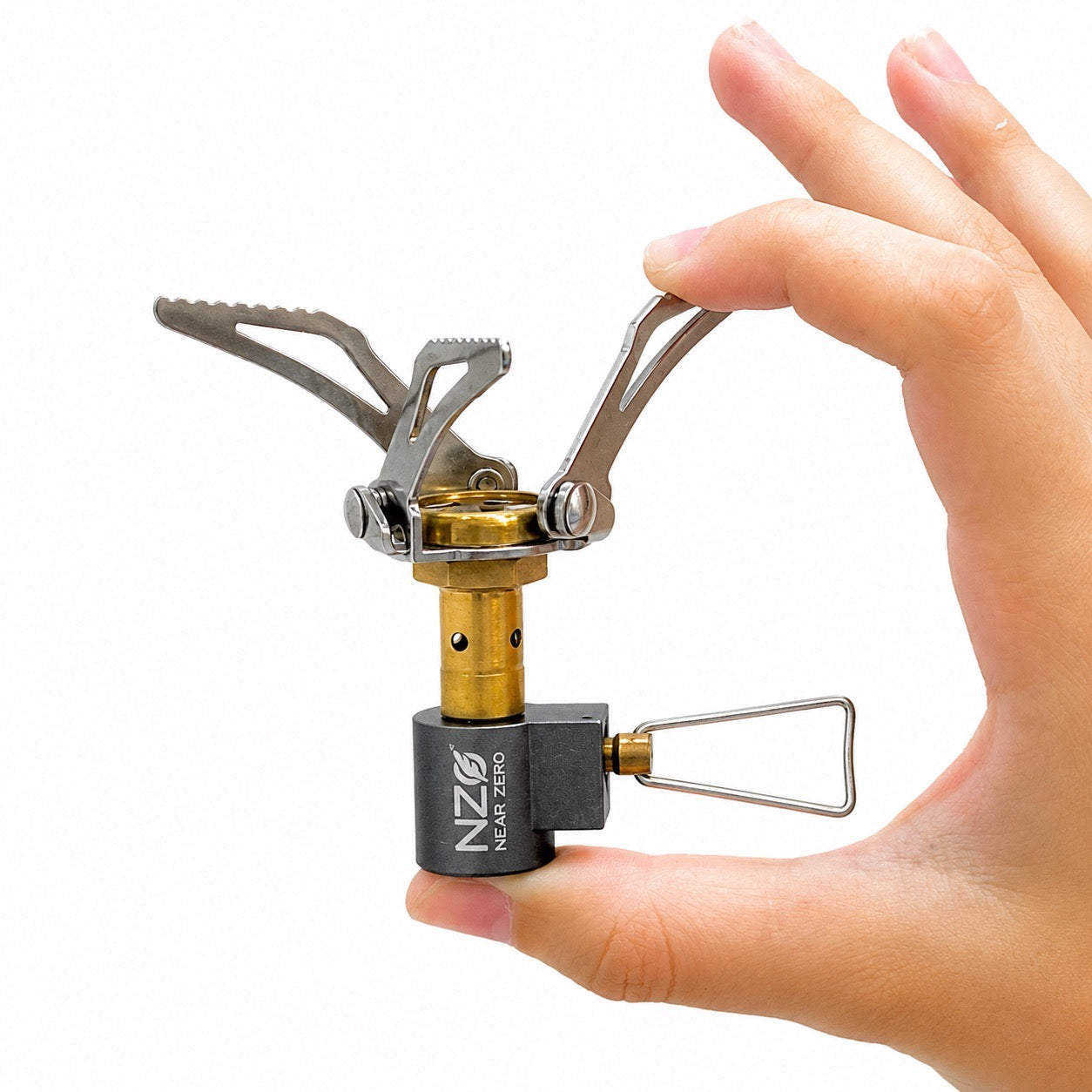 Near Zero Outdoor Gear mini stove held in hand, compact outdoor accessories for camping and backpacking.