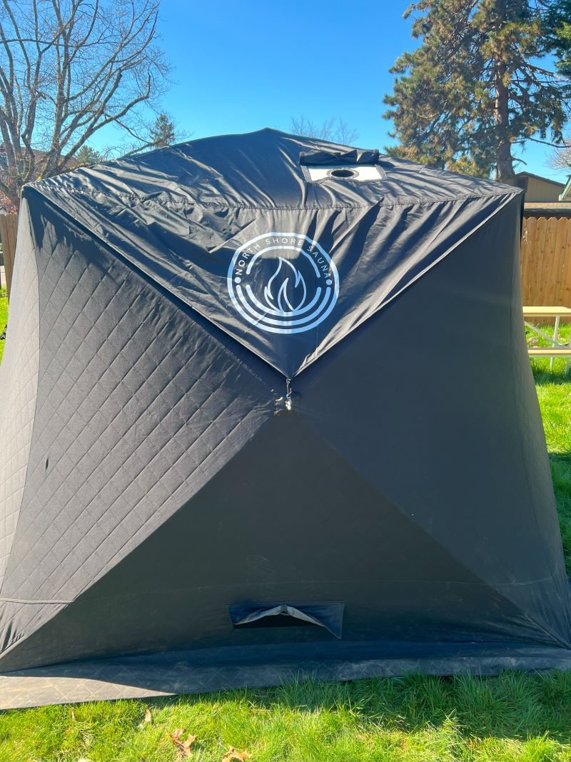 North Shore Sauna Nova 6 sauna tent rain cover with chimney hole for outdoor heat therapy and weather protection.