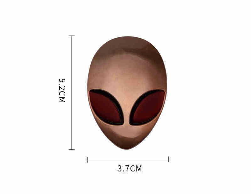 Alien metal emblem from Bean's Moto Booth featuring a detailed extraterrestrial design on a metal surface.