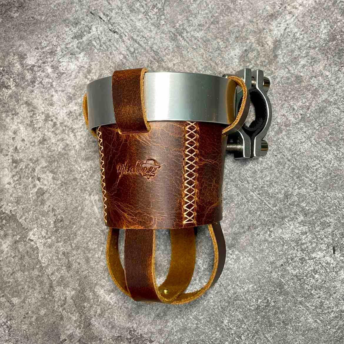 Handmade leather motorcycle water bottle holder in black with adjustable strap, designed for motorcycle accessories by Bean's Moto Booth.