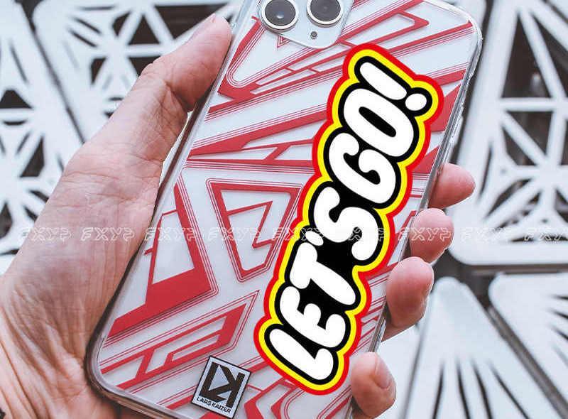 Colorful "Let's Go!" sticker by Bean's Moto Booth, perfect for decorating laptops, notebooks, or personal accessories.