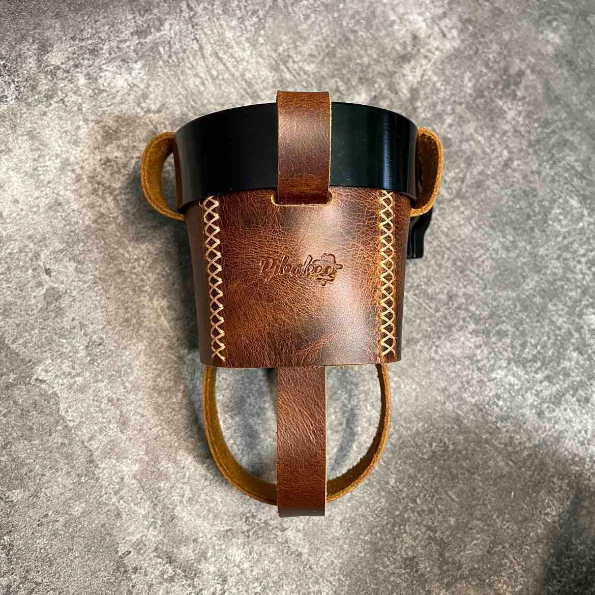 Handmade leather motorcycle water bottle holder from Bean's Moto Booth, designed as a durable accessory for motorcycle riding.