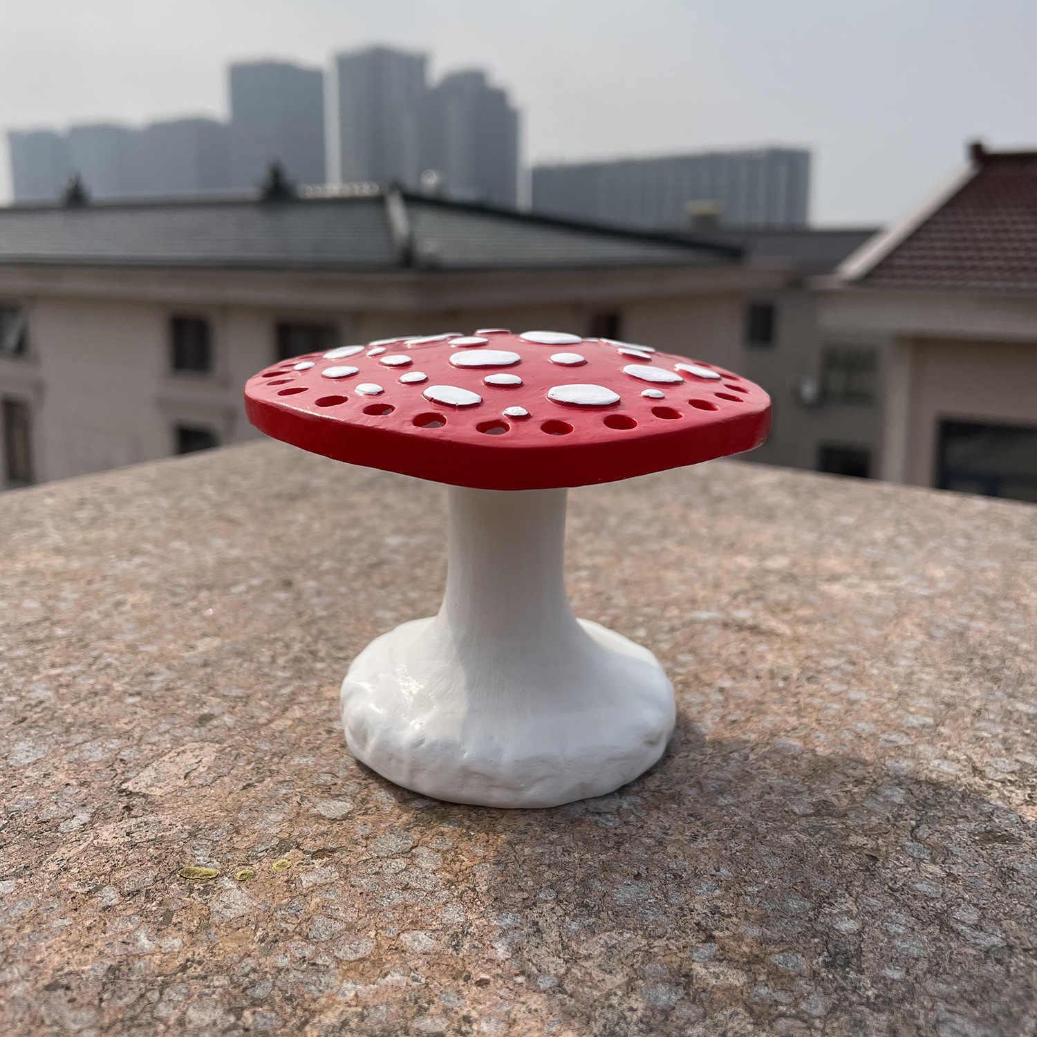 Bean's Moto Booth mushroom-shaped earring stand displaying multiple earrings on a wooden display.