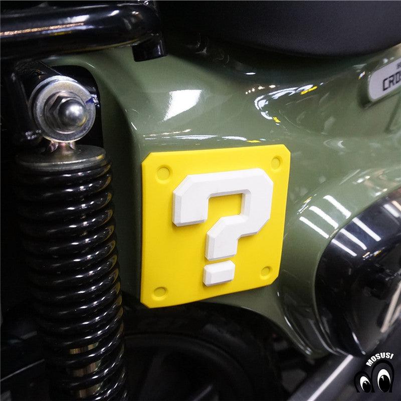 Vintage motorcycle question mark anti-collision sticker, decorative decal from Bean's Moto Booth with bold black and white design.