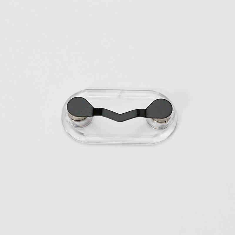 Magnetic eyeglass holder by Bean's Moto Booth with sleek design, securely holding glasses on a metal surface.