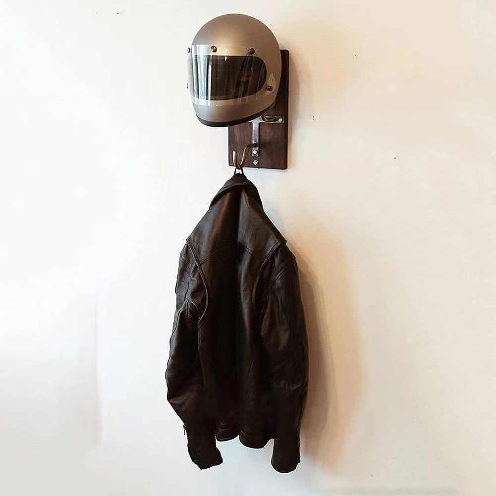 Bean's Moto Booth motorcycle helmet stand holding a black helmet on a wooden surface, showcasing its sturdy design and functionality.