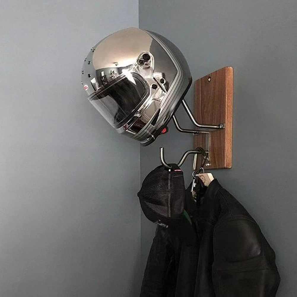 Bean's Moto Booth motorcycle helmet stand holding a black helmet on a wooden surface with a blurred background