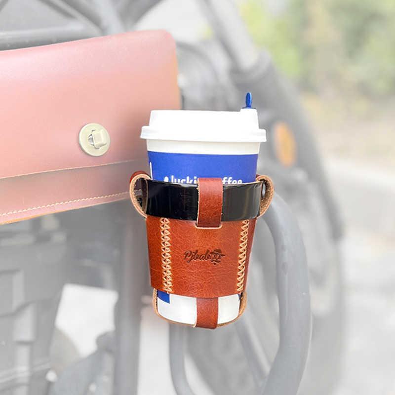 Handmade leather motorcycle water bottle holder from Bean's Moto Booth attached to a motorcycle handlebar.