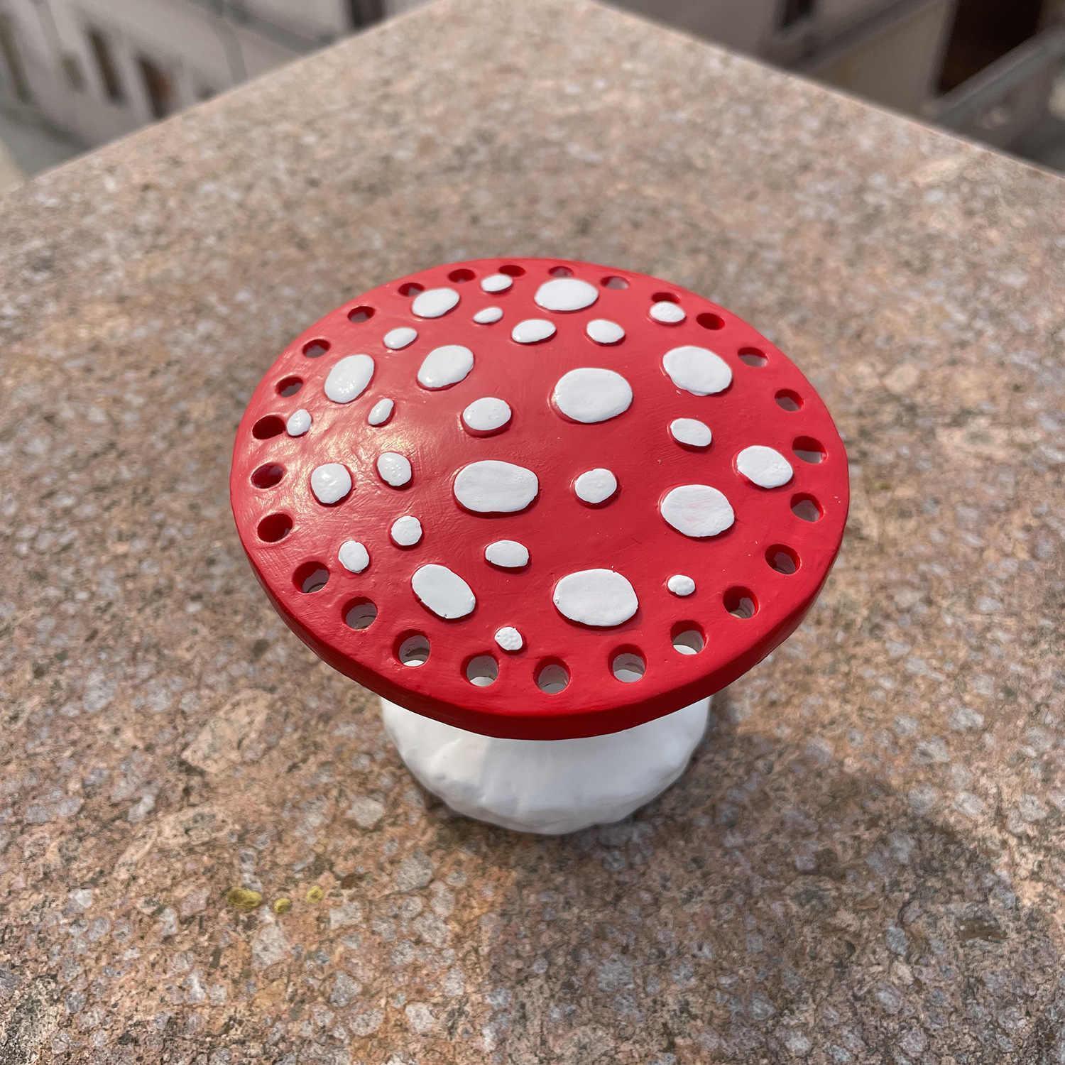 Bean's Moto Booth mushroom earring stands displayed on a table for organizing jewelry storage and display.