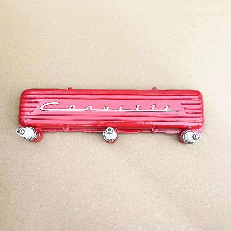 Vintage resin spark plug hook rack by Bean's Moto Booth featuring retro automotive-inspired hooks on a wooden base