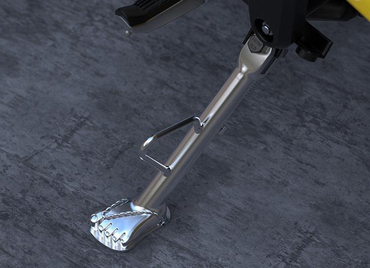 Stainless steel flip-flop motorcycle kickstand by Bean's Moto Booth, sturdy bike accessory for easy parking and stability.