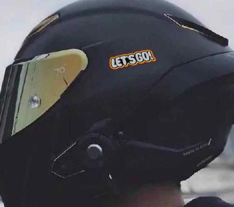 Colorful LET'S GO! sticker decor by Bean's Moto Booth featuring bold lettering on a vibrant background.