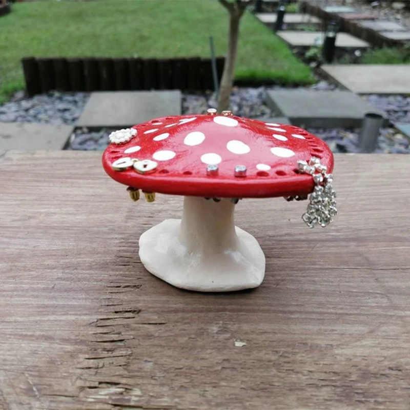 Bean's Moto Booth mushroom-shaped earring stand displaying multiple pairs of earrings on a white background