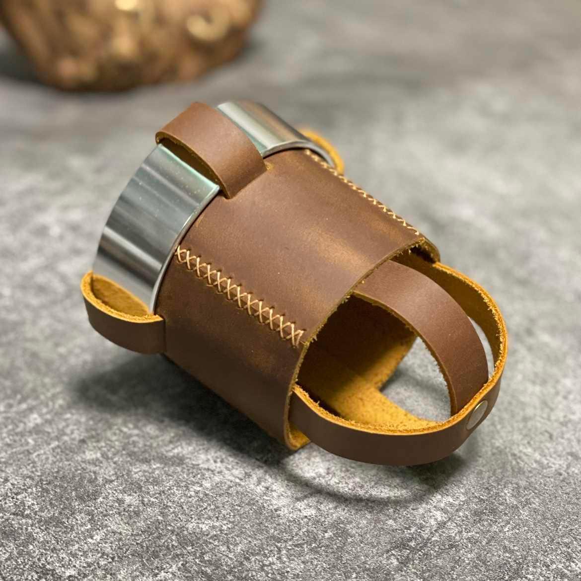 Handmade leather motorcycle water bottle holder with adjustable strap, designed for motorcycle accessories by Bean's Moto Booth.