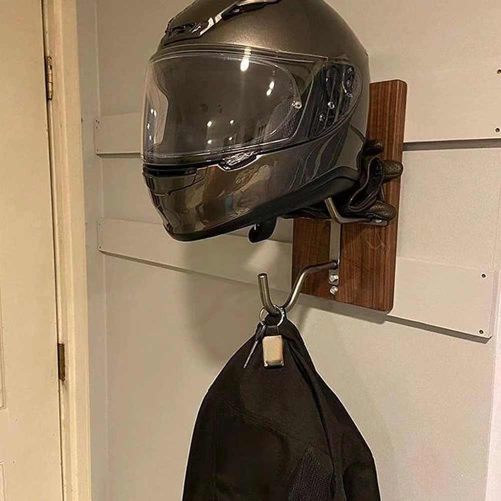 Bean's Moto Booth motorcycle helmet stand holding a black helmet on a wooden surface.