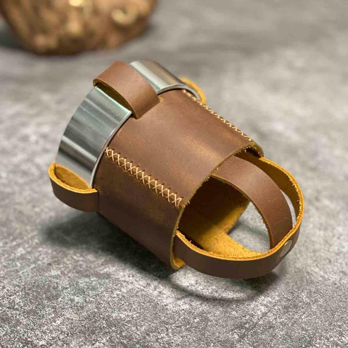 Handmade leather motorcycle water bottle holder with adjustable strap, designed for motorcycle accessories by Bean's Moto Booth.