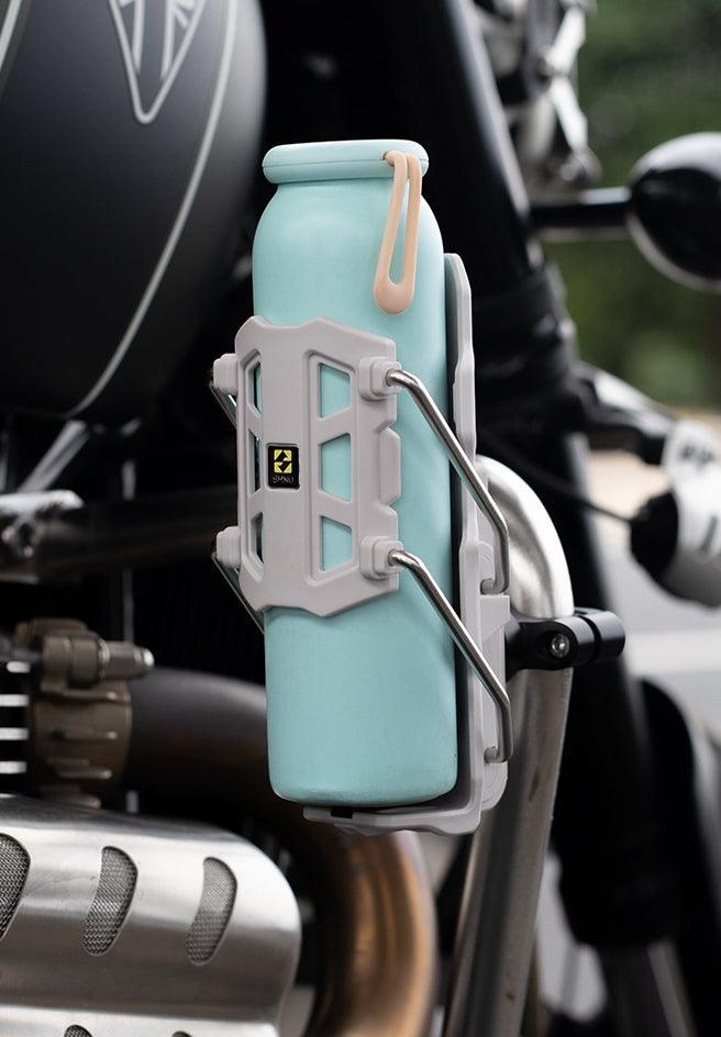 Bean's Moto Booth SMNU™ motorcycle adaptive anti-slip water bottle holder attached to motorcycle handlebar, secure and water-resistant accessory.