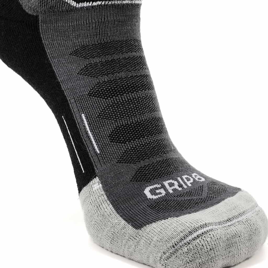 Three pairs of GRIP6 Obsidian Run ankle socks in midweight merino wool, showcasing their comfortable fit and dark gray color.