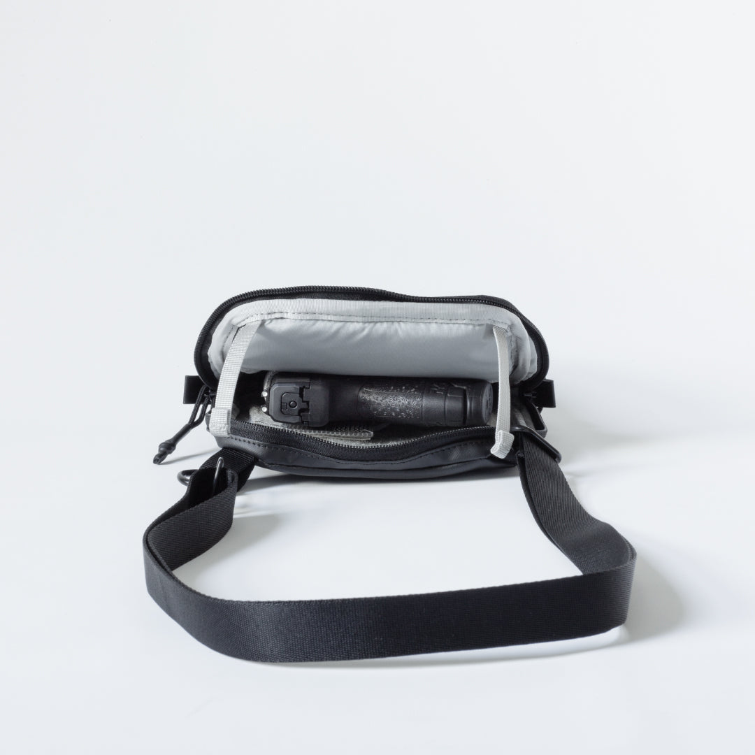 Open Elite Survival Systems Microguard Mini Crossbody Concealed Carry Bag showing interior pouch and organization compartments.
