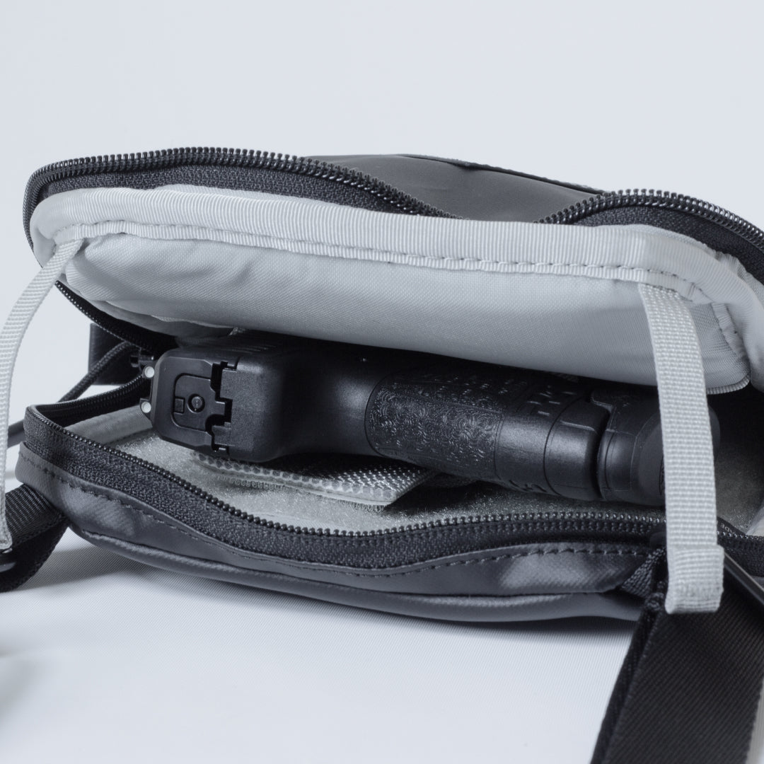 Open Elite Survival Systems Microguard Mini Crossbody Concealed Carry Bag showing interior compartments and discreet concealment features.