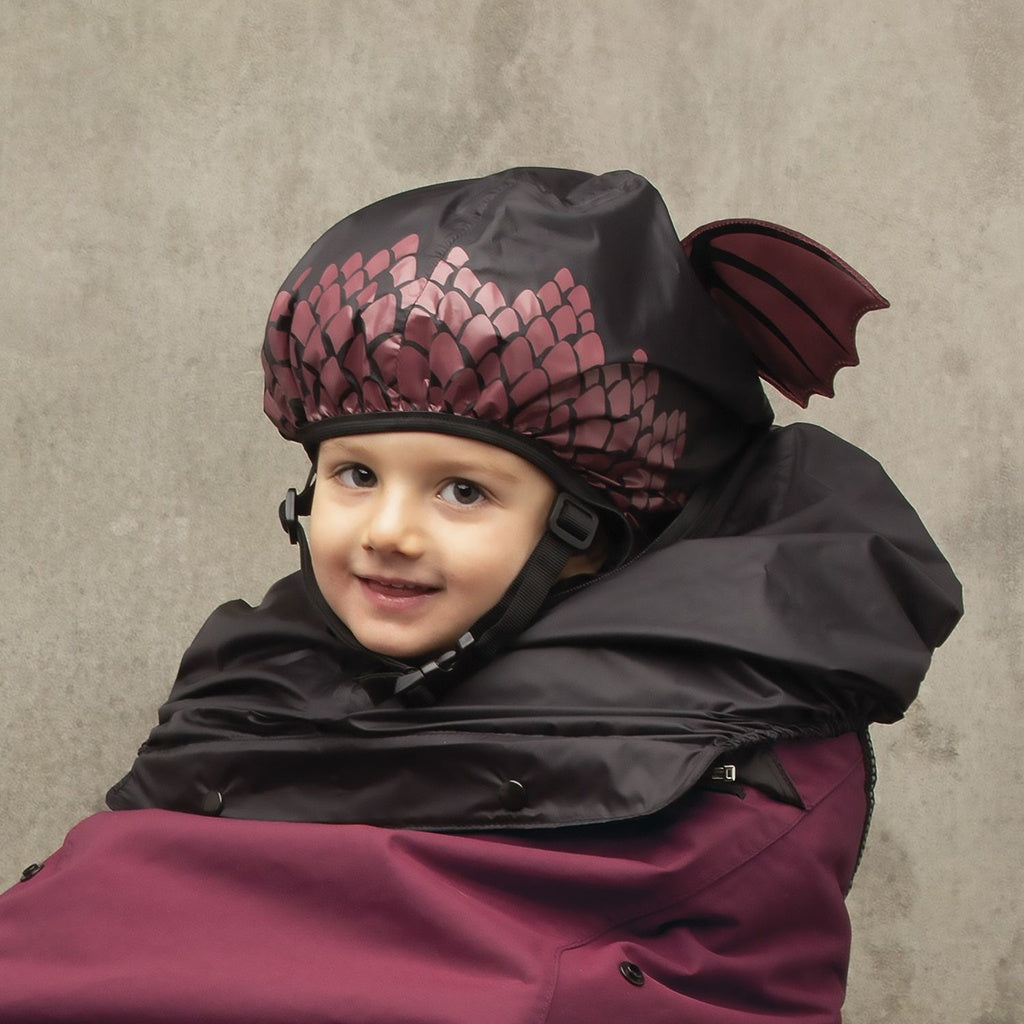 ZEITBIKE Tucano Urbano thermal child bike seat rain cover with hood, red dragon design, shown on a bicycle for outdoor riding.