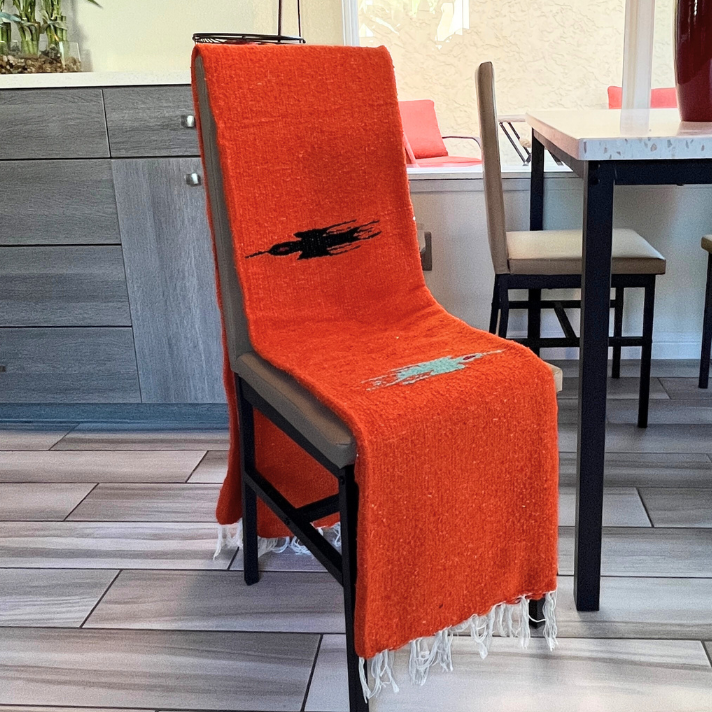 Orange Baja Thunderbird blanket by West Path, featuring vibrant tangerine color and Thunderbird design, cozy and decorative throw.