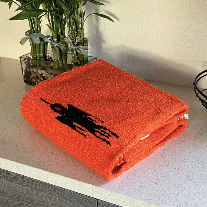 West Path Tangerine Orange Baja Thunderbird Blanket featuring vibrant orange Thunderbird design on soft blanket fabric.