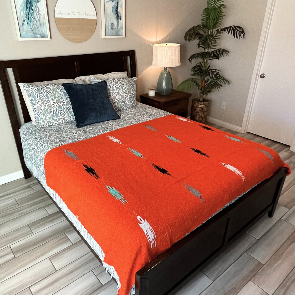Orange Baja Thunderbird blanket by West Path featuring a vibrant Thunderbird design on soft fabric.