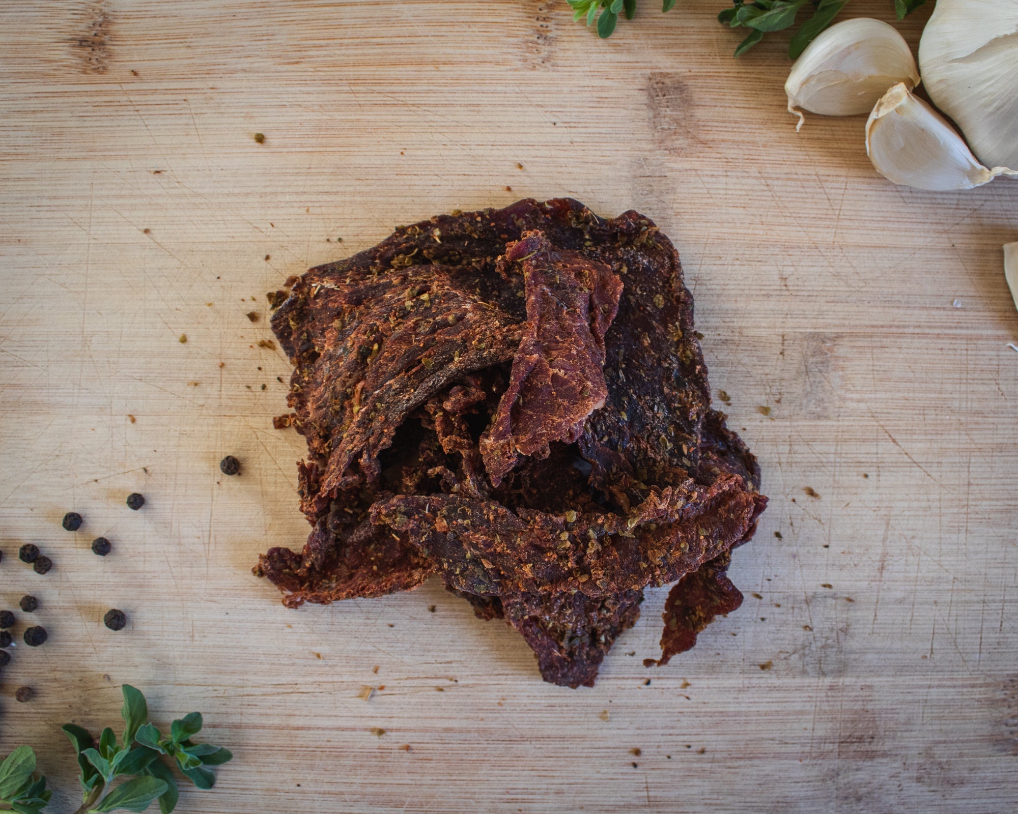 Cane Creek Jerky Bourbon and Brown Sugar Beef Jerky, original flavor, showing thick, glazed beef slices with a glossy finish.