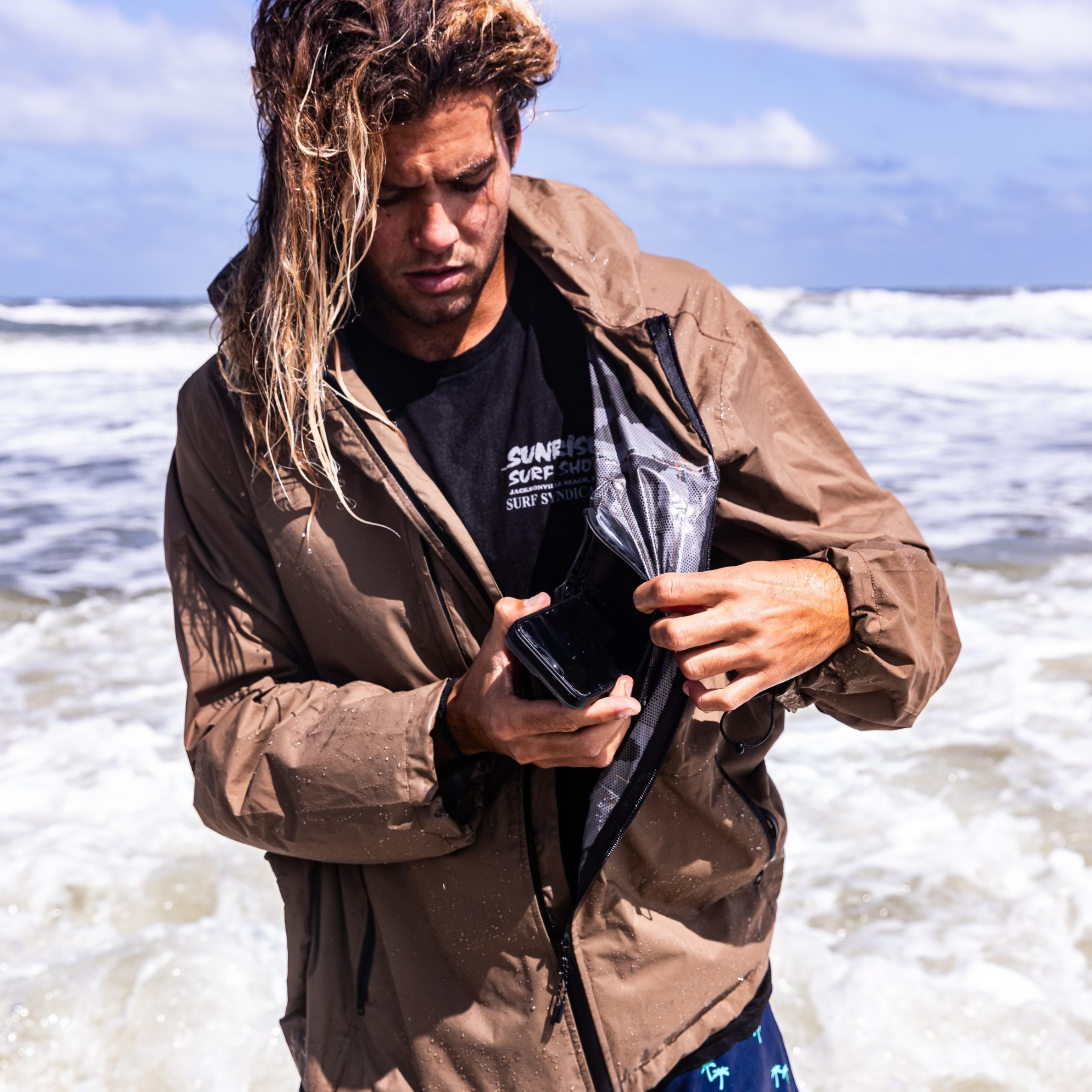Dry Pocket Outback waterproof rain jacket with a visible waterproof pocket, designed for fishing and outdoor rain protection.