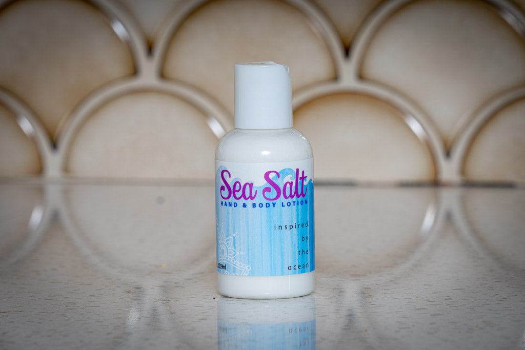 Essential Journeys sea salt hand and body lotion in a 16 oz or 2 oz container, featuring nourishing butters and salves.