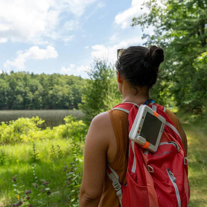 Alpenglow PackLite Titan 2-in-1 Power Lantern illuminating a backpack in an outdoor setting at night.