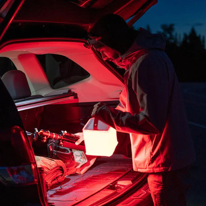 Alpenglow Readiness Supply PackLite Titan 2-in-1 Power Lantern in a gear trunk with red LED light visible.