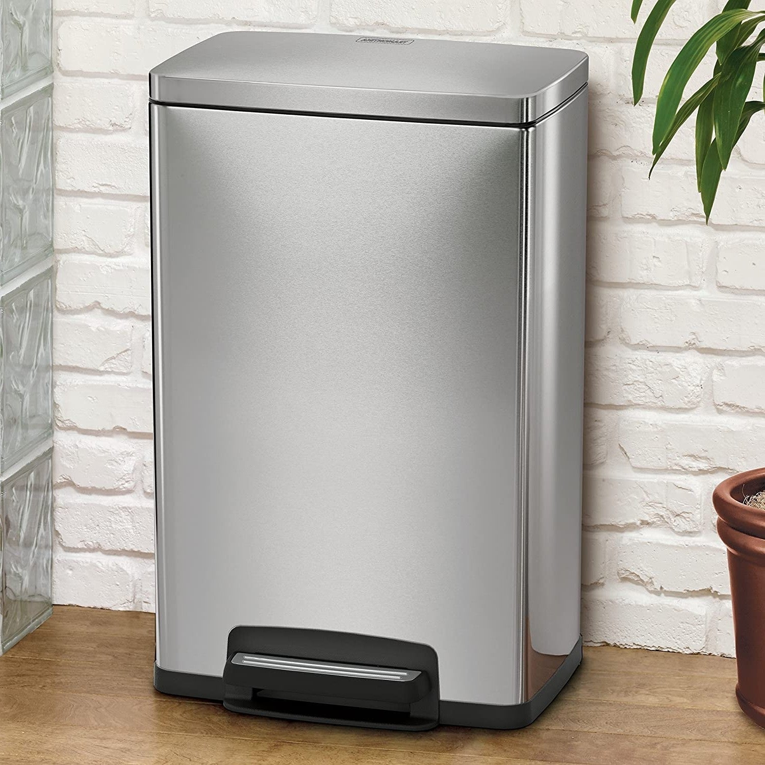 HomePacific 13-gallon stainless steel kitchen trash can with step lid, modern design and durable construction.