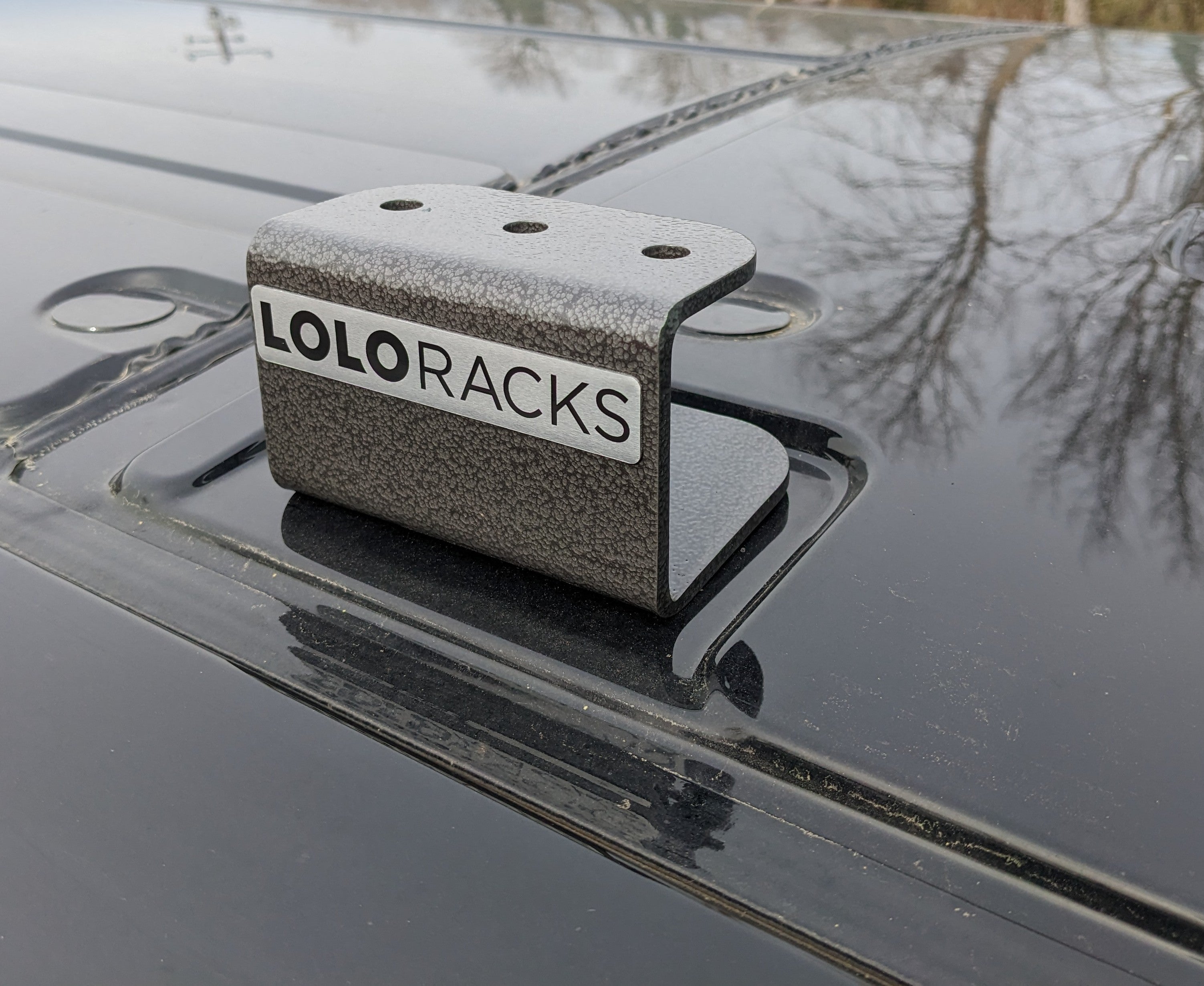 Pair of Ford Transit roof mounts by Lolo Racks, designed for van overland accessories, shown installed on a vehicle roof.