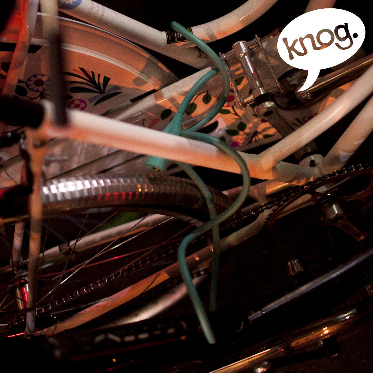 Knog Party Coil cable lock by ZEITBIKE, flexible coil lock with key, shown coiled with keyhole and durable cable.
