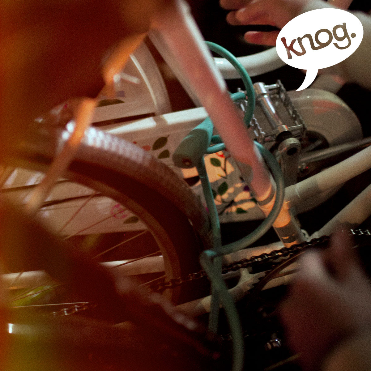 Knog Party Coil cable lock by ZEITBIKE, flexible coiled lock with key mechanism, shown in black with attached keys.