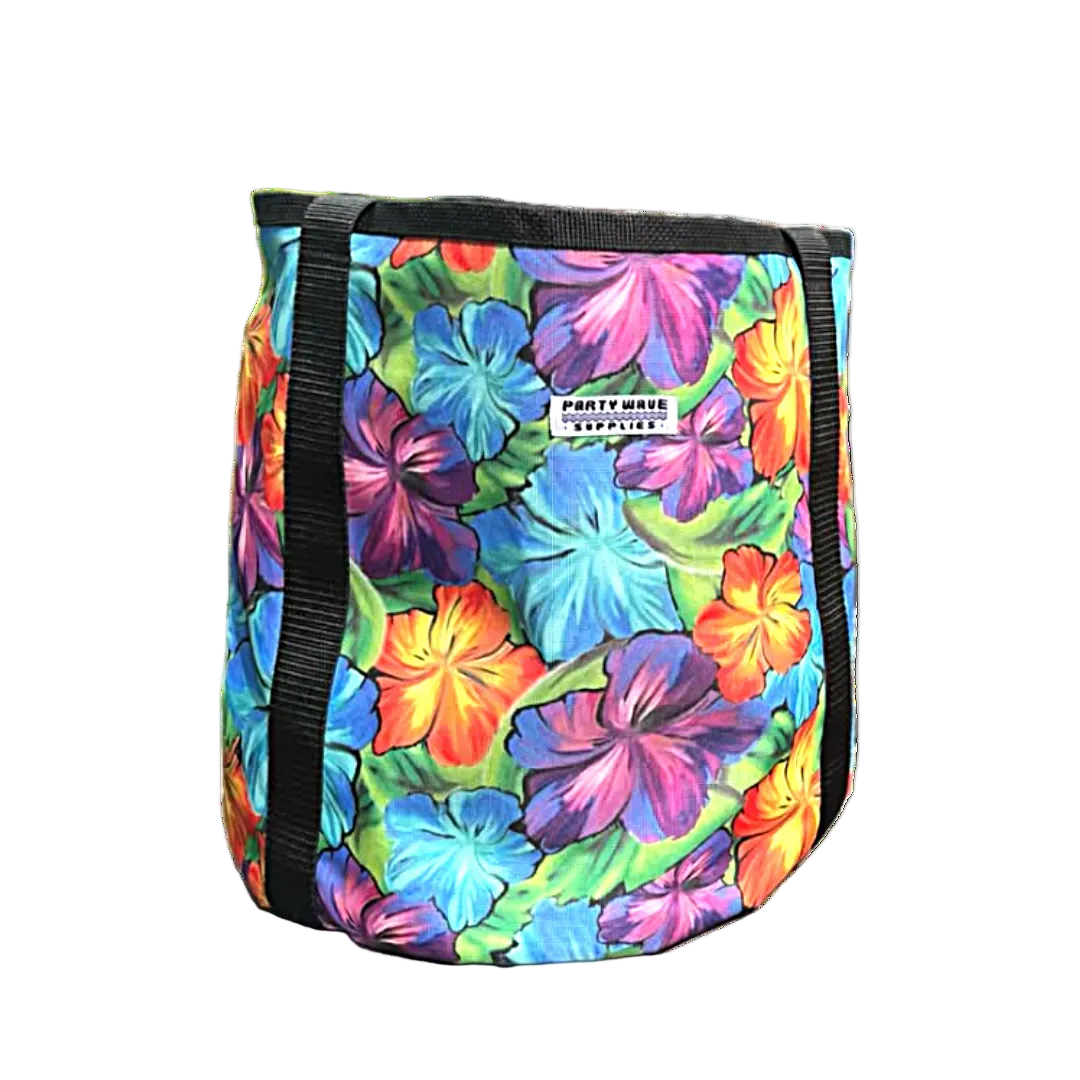 A cylindrical cooler bag with a vibrant multicolor tropical floral print featuring hibiscus flowers in shades of blue, purple, orange, and green. It has black webbing handles and a white brand label that reads 'PARTY WAVE SUPPLIES'.