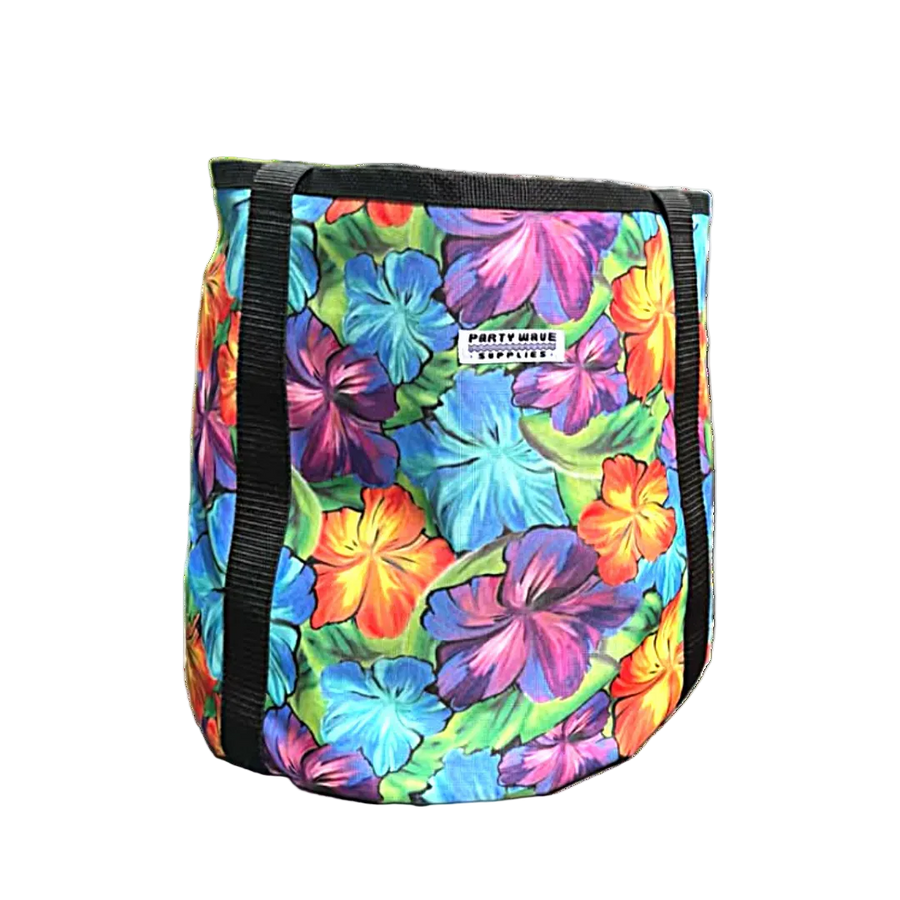 A cylindrical cooler bag with a vibrant multicolor tropical floral print featuring hibiscus flowers in shades of blue, purple, orange, and green. It has black webbing handles and a white brand label that reads 'PARTY WAVE SUPPLIES'.