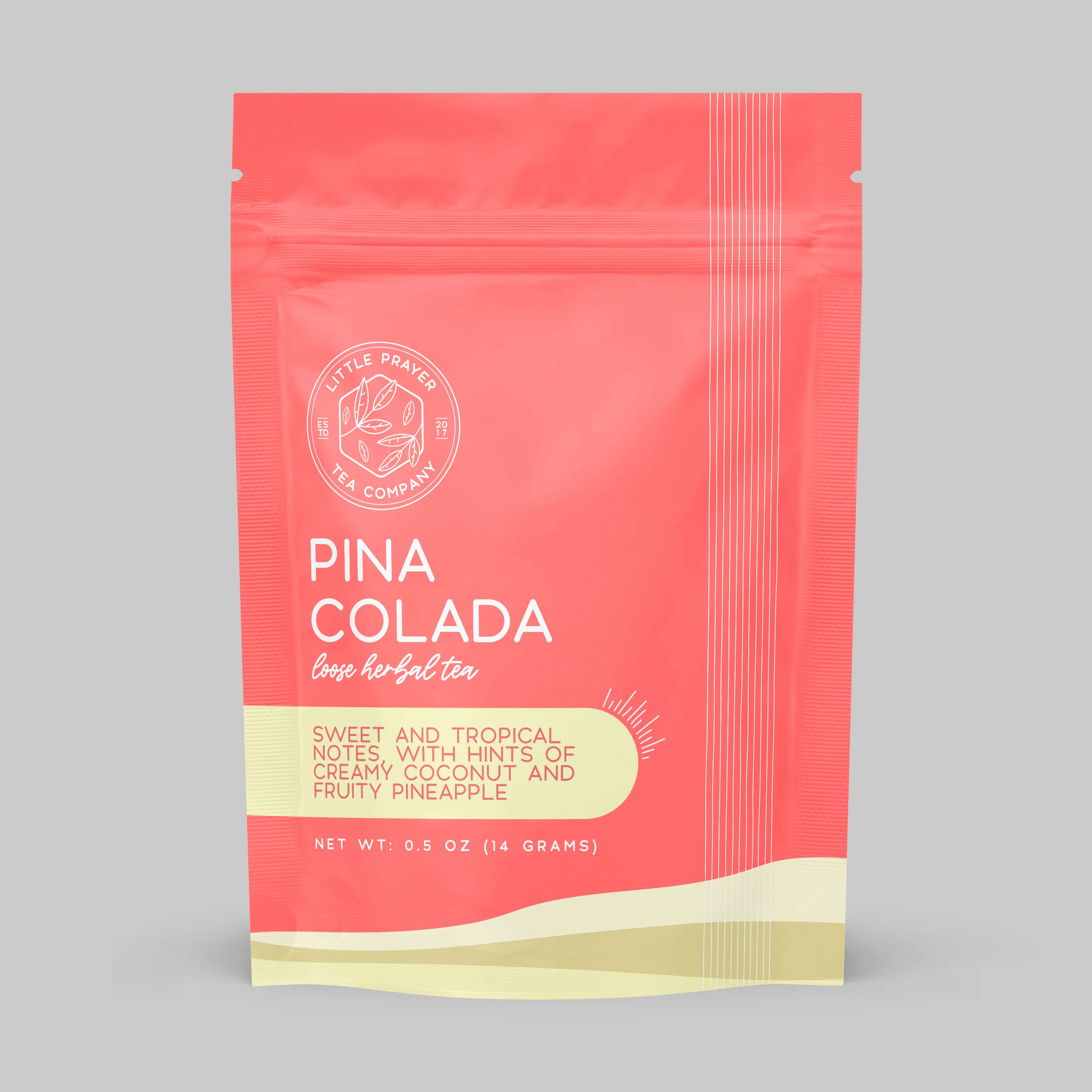Herbal tea sample featuring Pina Colada flavor from Little Prayer Tea Company, with tropical fruit and herbal ingredients in a clear cup.