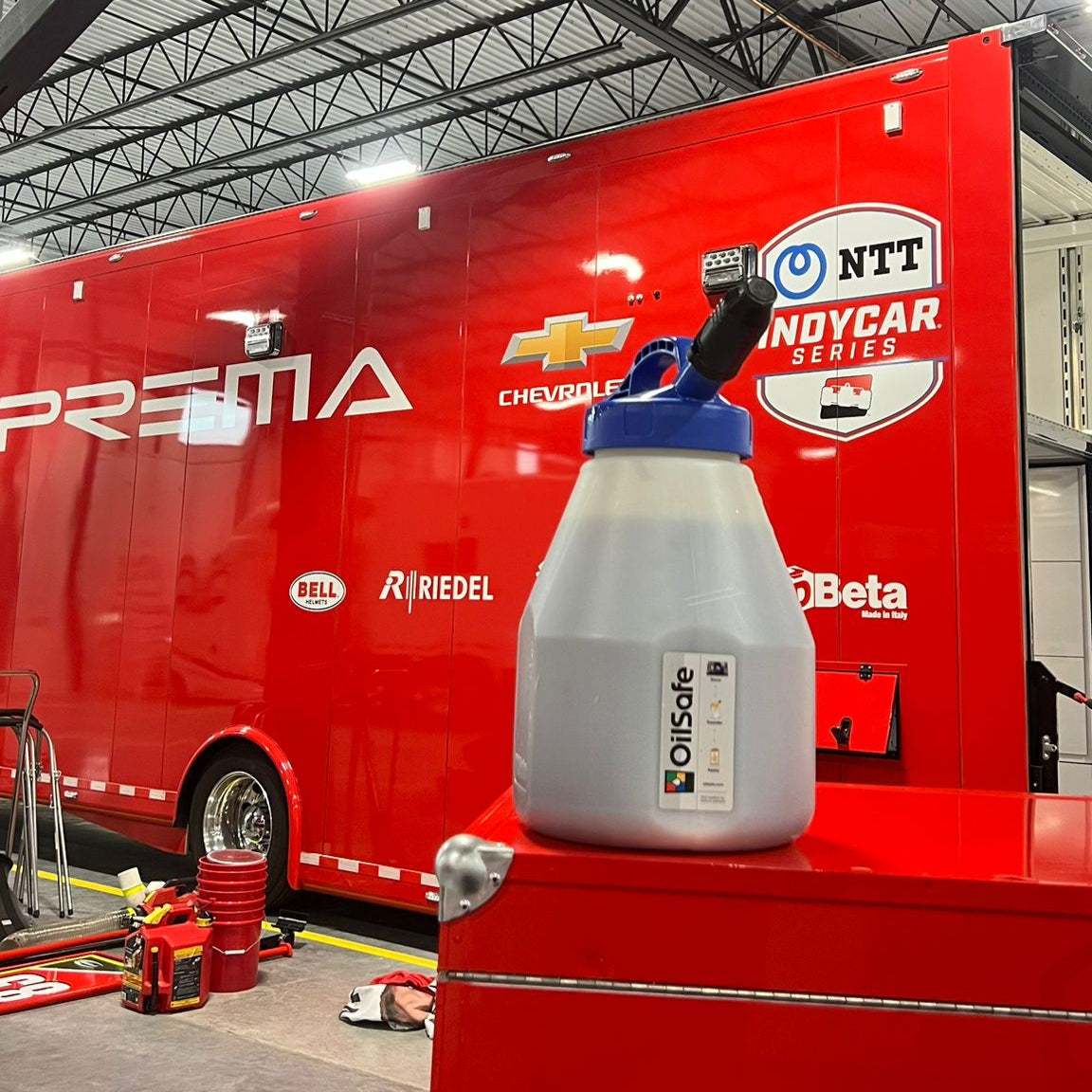 OilSafe Mini Stretch Spout lid for low-flow oil transfer, designed by DRIVEN Racing Shop, shown on a fluid storage container.