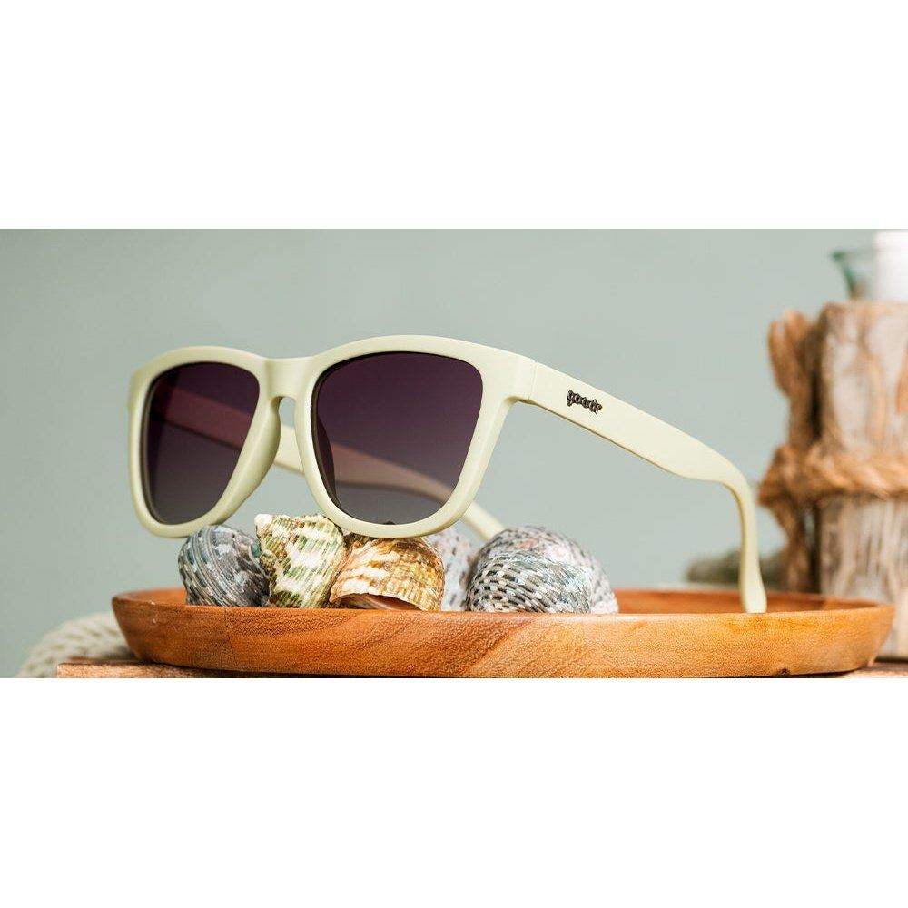 Rare Air Discs Dawn of a New Sage OG polarized sunglasses with sleek black frames and tinted lenses, styled as accessories.