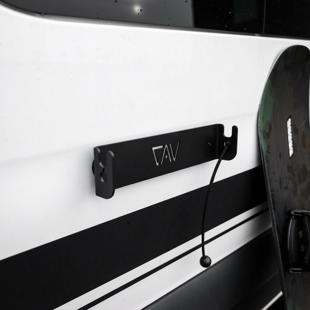 Canyon Adventure Vans magnetic ski and snowboard holder made in Utah, mounted on a vehicle roof rack for secure gear transport.