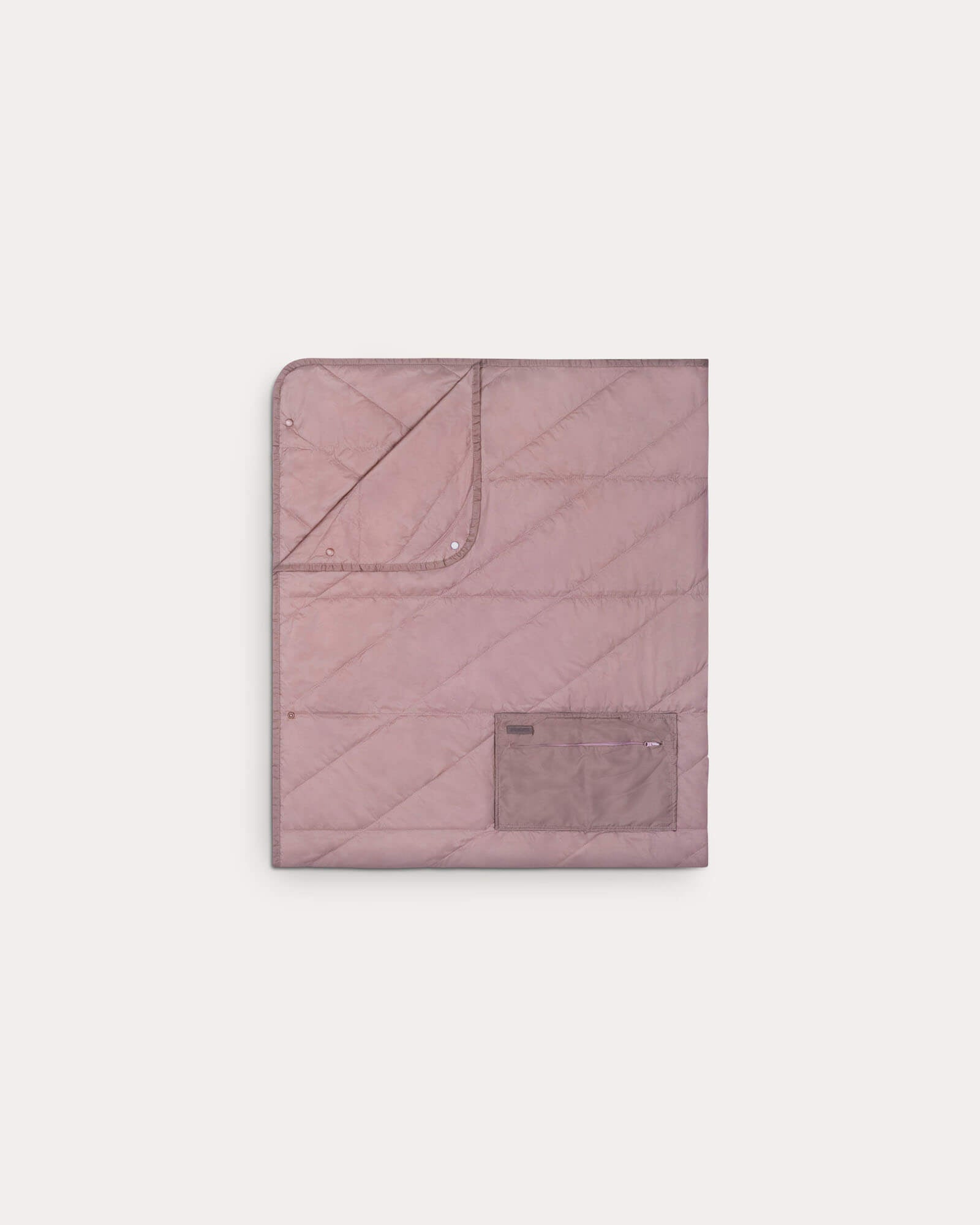 Gravel Layover™ travel blanket in quartz color, folded and packable for easy portability and warmth during travel.