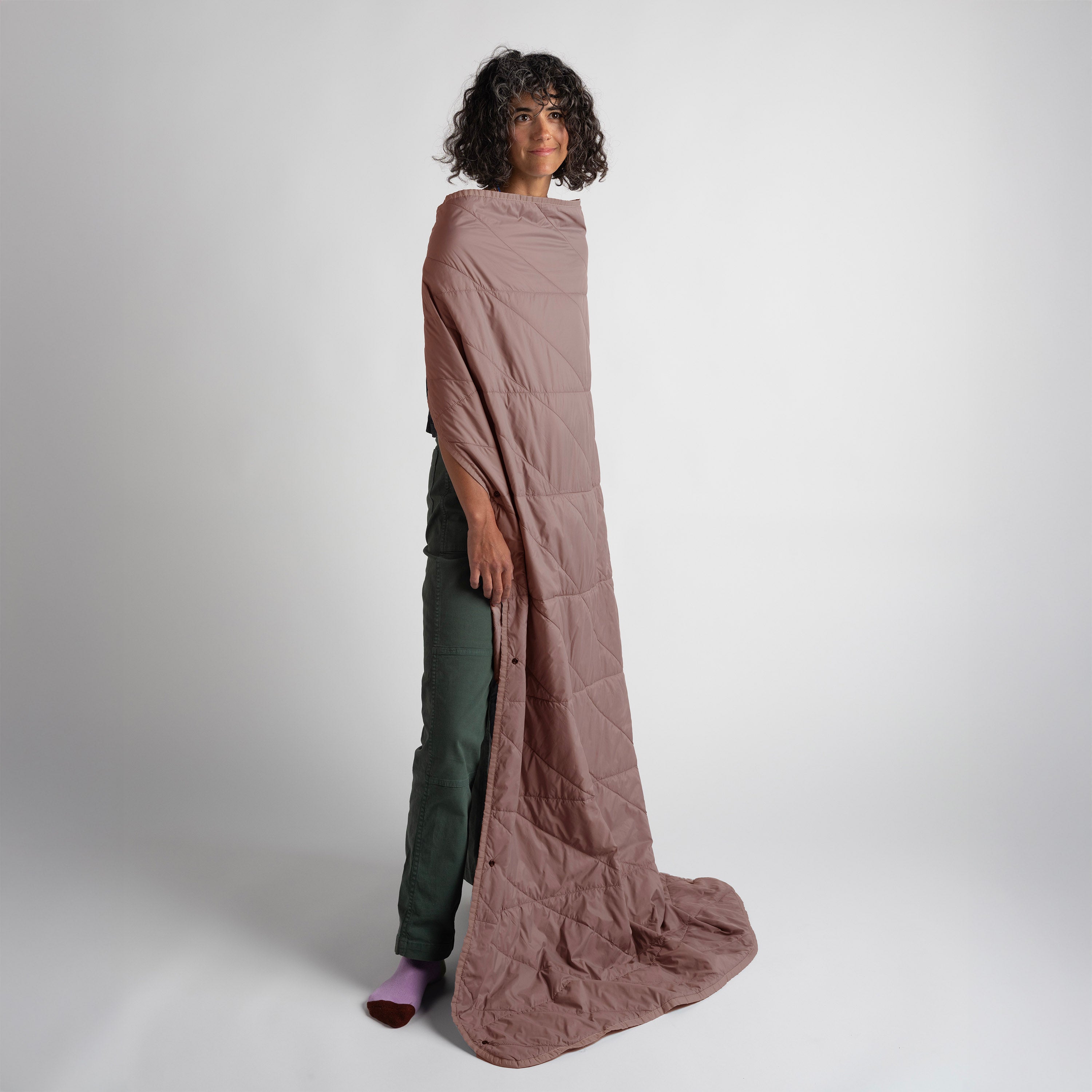 Gravel Layover™ Quartz travel blanket in soft, cozy fabric, shown folded with a neutral color and compact design for easy packing.
