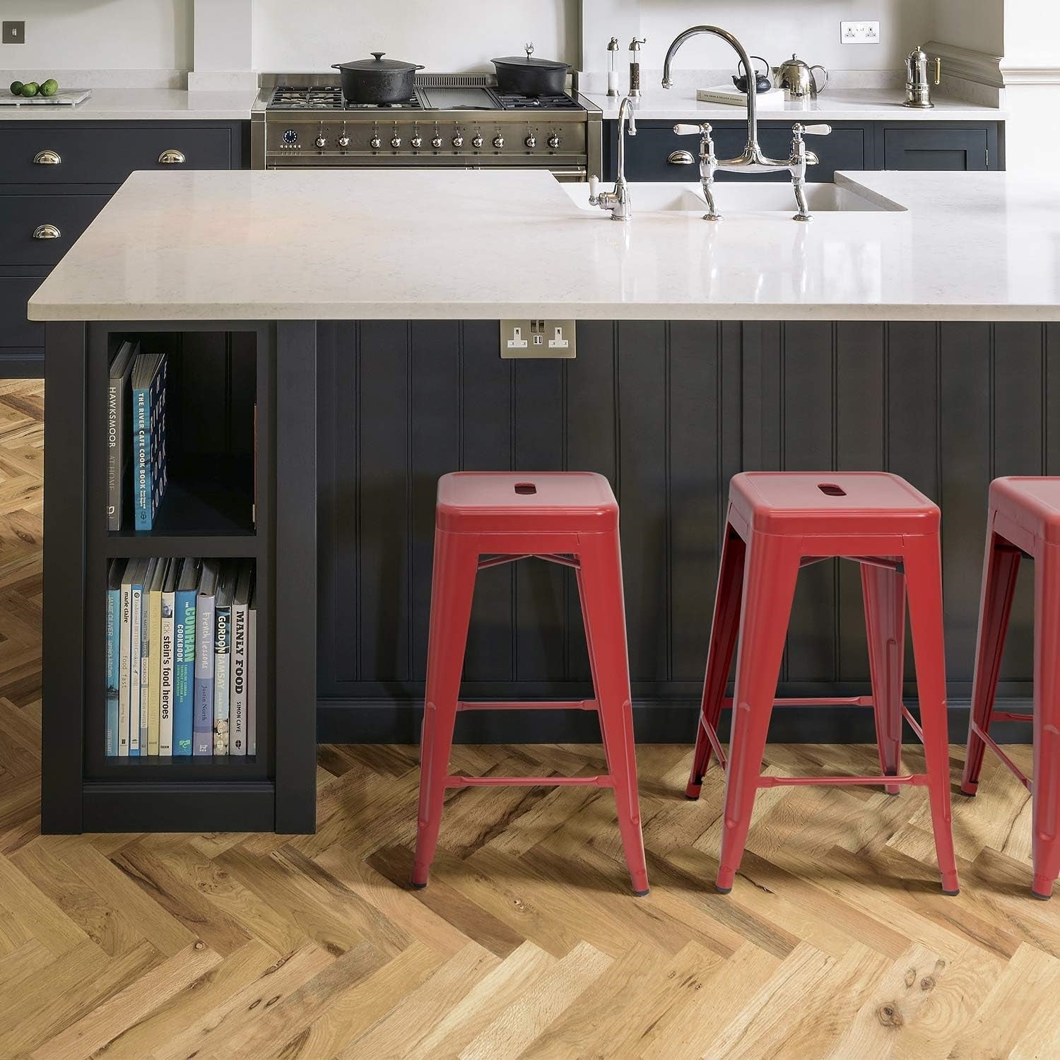 Set of four red metal backless stacking barstools for indoor or outdoor dining, with a sturdy metal frame and modern design.